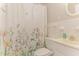 Charming bathroom featuring floral shower curtain, tiled walls, and white fixtures at 197 Country Routt Brown Rd, Pittsboro, NC 27312