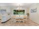 Bright dining room featuring a wood table with seating for six and large windows overlooking the backyard at 197 Country Routt Brown Rd, Pittsboro, NC 27312