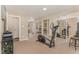Spacious exercise room with mirrored walls, workout equipment, and access to other living areas at 197 Country Routt Brown Rd, Pittsboro, NC 27312