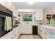 Well-maintained kitchen with white cabinets, stylish tile accents, and modern appliances at 197 Country Routt Brown Rd, Pittsboro, NC 27312