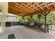 Covered porch featuring wood beams, outdoor seating with accent pillows, and stylish ceiling fan at 197 Country Routt Brown Rd, Pittsboro, NC 27312