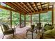 Relaxing screened porch with outdoor seating and views of the private backyard at 197 Country Routt Brown Rd, Pittsboro, NC 27312