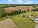 Stunning aerial view capturing a picturesque property featuring a home, pond, and cultivated land at 1993 Lucy Garrett Rd, Roxboro, NC 27574