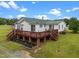 Expansive backyard deck with seating areas, ideal for gatherings and enjoying the outdoors at 1993 Lucy Garrett Rd, Roxboro, NC 27574