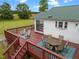 Backyard deck featuring an outdoor dining set and lounge chairs overlooking a peaceful landscape at 1993 Lucy Garrett Rd, Roxboro, NC 27574