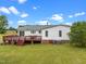 Spacious backyard features a large deck, perfect for outdoor entertaining and relaxation at 1993 Lucy Garrett Rd, Roxboro, NC 27574