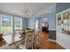 Charming dining room featuring a wood table, an elegant chandelier, and natural light from the windows at 1993 Lucy Garrett Rd, Roxboro, NC 27574