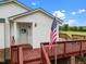 Inviting front porch with an American flag, offering a warm welcome to this delightful home at 1993 Lucy Garrett Rd, Roxboro, NC 27574