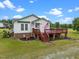 Quaint home featuring a charming porch, American flag, and meticulously landscaped front yard at 1993 Lucy Garrett Rd, Roxboro, NC 27574