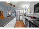 Modern kitchen featuring stainless steel appliances, white cabinets, an island, and an eat-in area at 1993 Lucy Garrett Rd, Roxboro, NC 27574