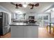 Spacious kitchen featuring a central island, stainless steel refrigerator, and white cabinets at 1993 Lucy Garrett Rd, Roxboro, NC 27574