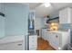 Functional laundry room featuring modern washer and dryer units, storage cabinets, and stylish decor at 1993 Lucy Garrett Rd, Roxboro, NC 27574