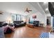 Comfortable living room featuring leather sofas, a ceiling fan, a fireplace, and plenty of natural light at 1993 Lucy Garrett Rd, Roxboro, NC 27574