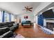 Spacious living room showcasing leather sofas, a fireplace, and an open floor plan at 1993 Lucy Garrett Rd, Roxboro, NC 27574