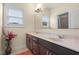 Bright bathroom with double sink vanity, lots of counter space, mirror and window providing lots of light at 200 Vintage Hill Cir, Apex, NC 27539
