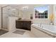 Elegant bathroom featuring a walk-in shower and a soaking tub, providing a luxurious retreat at 200 Vintage Hill Cir, Apex, NC 27539