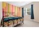 Bright bedroom with colorful accent wall and large window allowing for natural light at 200 Vintage Hill Cir, Apex, NC 27539