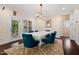 Elegant dining room featuring a modern table and six chairs. Hardwood floors and modern lighting at 200 Vintage Hill Cir, Apex, NC 27539