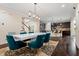 Modern dining room open to the kitchen. Contemporary table, six chairs and hardwood floors at 200 Vintage Hill Cir, Apex, NC 27539