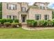 Close up of a charming brick home with manicured landscaping and a welcoming front entrance at 200 Vintage Hill Cir, Apex, NC 27539
