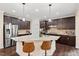 Kitchen with granite counters, island with barstool seating and stainless appliances at 200 Vintage Hill Cir, Apex, NC 27539