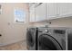 Well-equipped laundry room with washer, dryer, window and storage cabinets, making laundry chores easy at 200 Vintage Hill Cir, Apex, NC 27539