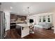 Open-concept kitchen and living area with hardwood floors, lots of cabinets and natural light at 200 Vintage Hill Cir, Apex, NC 27539