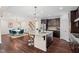 Modern kitchen and dining area with hardwood floors, stainless appliances, granite counters and breakfast bar at 200 Vintage Hill Cir, Apex, NC 27539