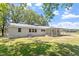 Rear of the property showing the brick home with metal roof and covered patio at 2003 Broadway Rd, Sanford, NC 27332