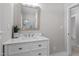 Bathroom features modern vanity with marble countertops, decorative plant, painted walls and updated mirror at 2003 Broadway Rd, Sanford, NC 27332