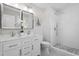 Modern bathroom with double vanity, stylish mirrors, and a glass-enclosed shower with white tiling at 2003 Broadway Rd, Sanford, NC 27332
