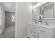 Bathroom features double vanity with marble countertop, modern mirrors and white-painted cabinets at 2003 Broadway Rd, Sanford, NC 27332