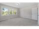 Bright bedroom with hardwood floors, neutral paint, carpet, and large windows offering ample natural light and a closet at 2003 Broadway Rd, Sanford, NC 27332