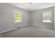 Cozy bedroom with neutral paint, carpet flooring, and natural light from two windows at 2003 Broadway Rd, Sanford, NC 27332