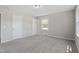 Cozy bedroom featuring neutral paint, carpet flooring, and natural light from a window at 2003 Broadway Rd, Sanford, NC 27332