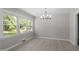 Airy dining room with natural light, showcasing a modern chandelier and spacious layout on wood-look floors at 2003 Broadway Rd, Sanford, NC 27332