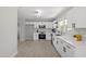 Contemporary kitchen featuring white cabinetry, stainless steel appliances, and modern lighting at 2003 Broadway Rd, Sanford, NC 27332