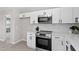 Modern white kitchen with stainless steel appliances and sleek, minimalist cabinets at 2003 Broadway Rd, Sanford, NC 27332