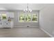 Open concept kitchen and dining area featuring updated appliances, cabinetry, and light wood flooring at 2003 Broadway Rd, Sanford, NC 27332