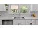 Bright kitchen featuring stainless steel appliances, white cabinetry, and a view overlooking the backyard at 2003 Broadway Rd, Sanford, NC 27332