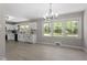 Open concept kitchen and dining area featuring updated appliances, cabinetry, and light wood flooring at 2003 Broadway Rd, Sanford, NC 27332