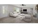 Bright living room featuring a modern white sofa, ceiling fan, neutral tones and lots of natural light at 2003 Broadway Rd, Sanford, NC 27332