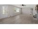Bright living room featuring a ceiling fan, neutral paint, light wood flooring, and a decorative fireplace at 2003 Broadway Rd, Sanford, NC 27332
