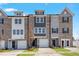 Modern townhome exterior with brick facade, attached garages, and well-maintained landscaping at 2034 Fishamble St # 30, Fuquay Varina, NC 27526
