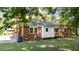 Back exterior showcasing the brick siding, an addition, and an AC unit at 208 Essex Rd, Nashville, NC 27856