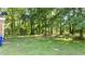 Expansive backyard featuring lush green lawn and mature trees for ample shade at 208 Essex Rd, Nashville, NC 27856
