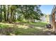 Large grassy backyard featuring an outdoor shed and mature trees for shade at 208 Essex Rd, Nashville, NC 27856