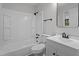 A clean bathroom with white fixtures, a sink vanity, and a shower-tub combo at 208 Essex Rd, Nashville, NC 27856
