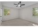 An empty bedroom featuring two windows with natural light and a ceiling fan at 208 Essex Rd, Nashville, NC 27856