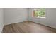 Cozy bedroom featuring modern vinyl flooring, a large window, and neutral paint at 208 Essex Rd, Nashville, NC 27856
